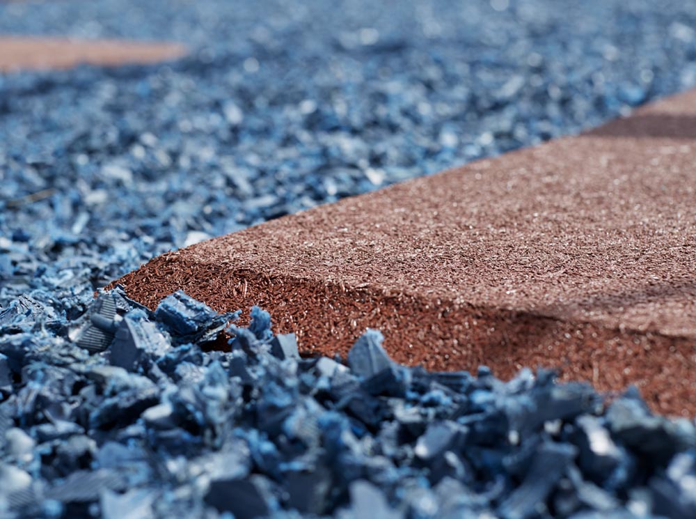 A close up of a Rubberific Swing and Playground Mat from Rubber Mulch.